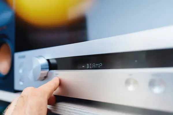 stock image BIAMP signage on the preamplifier, useful for Volume level offset based on main volume, in a luxury audiophile room, emphasizing advanced audio control and premium sound quality - light flare