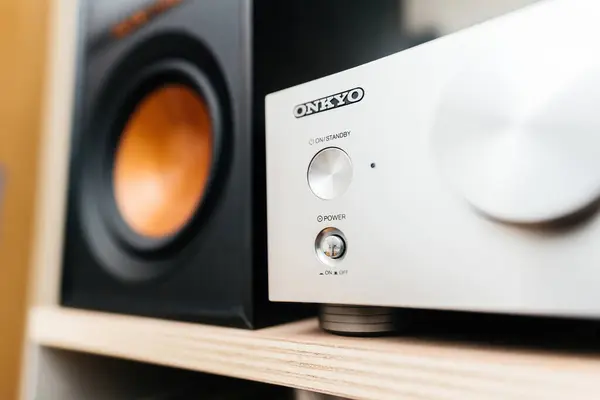 stock image Paris, France - Jun 3, 2024: Onkyo logotype on the P-3000R preamplifier next to a Klipsch Reference loudspeaker in an audiophile room, highlighting premium audio equipment in a dedicated listening