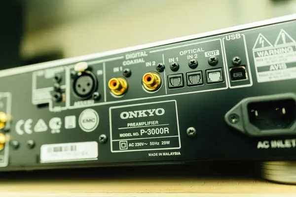 stock image Paris, France - Jun 3, 2024: Focus on the optical in and out ports of the Onkyo P-3000R reference preamplifier, highlighting its advanced digital connectivity options and precise audio signal