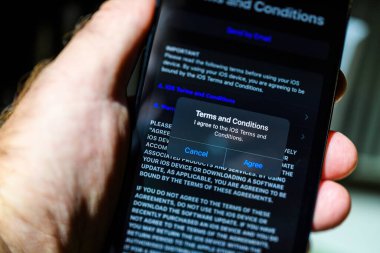 Londra, İngiltere - Bölüm 28, 2023: Bir erkek, kurulum ve boks sırasında iPhone 15 Pro Max 'i tutuyor, koşulları ve koşulları kabul ederek. Bu, aygıtın kullanımının başlangıcıdır