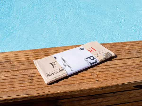 stock image Palma, Spain - Jul 10, 2024: The Financial Times newspaper is placed near a pool, ready to be read, reflecting a setting focused on business news and relaxation