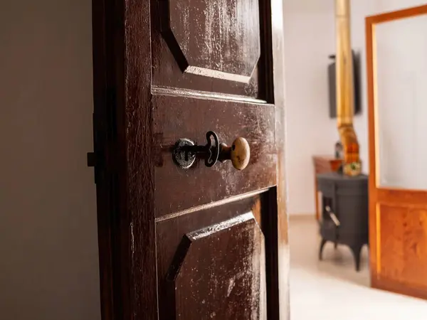 stock image An old wooden door with a wooden chimney in the background reflects the simple elegance and vintage charm of a minimalist home setting