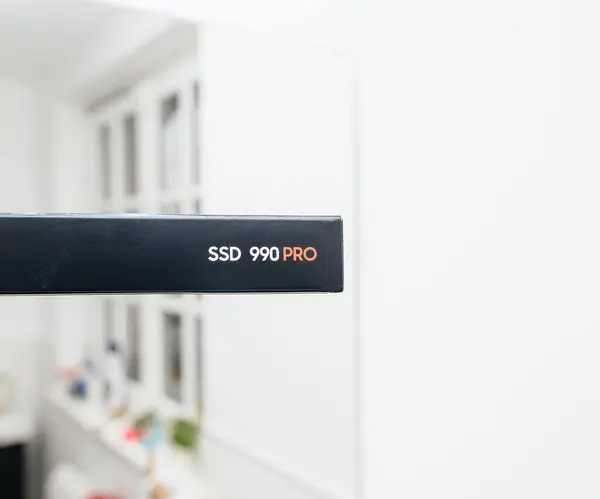 stock image Frankfurt, Germany - Apr 3, 2024: A Samsung SSD 990 Pro is placed in its cardboard packaging, set against a softly defocused room background, highlighting the product in a subtle, ambient setting