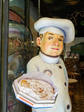 Palma, Spain - Jul 8, 2024: A statue of a baker holding an Ensaimada pastry outside Forn de Sant Cristo, a renowned bakery in Palma, Mallorca, known for its traditional Mallorcan treats clipart