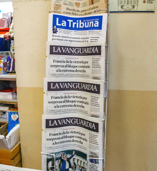 stock image Palma, Spain - Jul 8, 2024: Newspaper stand in Palma, Mallorca, displaying La Vanguardia with the headline about Frances surprising election victory for the bloc opposing the far-right, alongside La