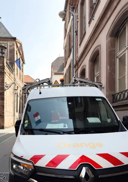 stock image Strasbourg, France - Aug 23, 2024: An Orange Telecom service van with visible inscription parked in the central part of a French city, with Haussmannian buildings in the background