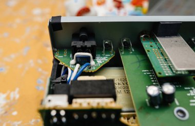 Paris, France - Feb 8, 2023: A detailed close-up of the internal circuitry of an Onkyo CD player, highlighting capacitors and connections essential for audio performance clipart