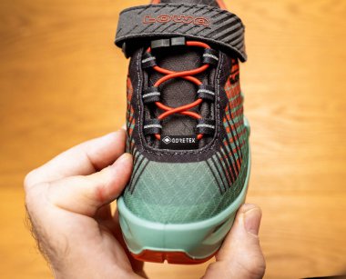 Paris, Fransa - 13 Nisan 2024: Gore-Tex teknolojisiyle bir Lowa yürüyüş ayakkabısının önü, canlı renklere ve açık hava maceraları için güvenli bağcıklara sahip