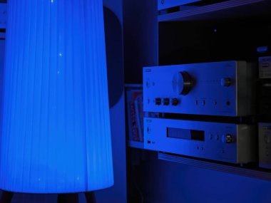 Frankfurt, Germany - Jul 21, 2024: Onkyo A-9150 amplifier and NS-6170 Network player in a dimly lit audiophile room, accentuated by a soft blue light ambiance for a high-end listening experience