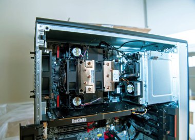 Paris, France - Nov 25, 2020: Interior view of the Lenovo ThinkStation P620, displaying the AMD Threadripper Pro CPU, cooling system, internal components, and organized cable management clipart