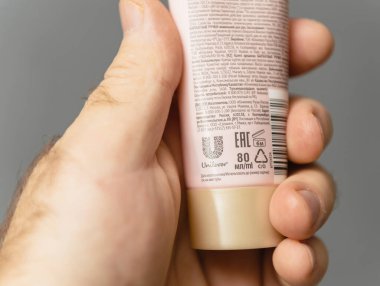 Paris, France - Jan 18, 2025: Back view of Velvet Hands hand cream tube, showing 80 mL packaging details, usage instructions, and manufacturing information by Unilever clipart