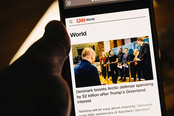 Paris, France - Jan 28, 2025: Smartphone screen displaying a CNN World news article about Denmark increasing Arctic defense spending by USD 2 billion following interest in Greenland, with a related image