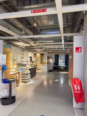 Paris, Fransa - 14 Ekim 2024: Bir IKEA mağazasının içinde, modern ışıklandırma altında, bir çıkış ve yangın söndürme göstergeleri de dahil olmak üzere net bir tabela ile iyi organize edilmiş mutfak düzenlemelerini görüntüler..