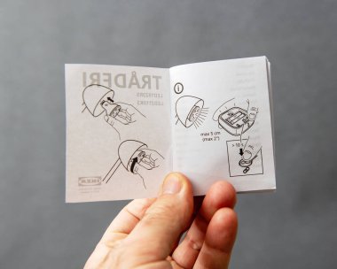 Paris, Fransa - 10 Mart 2025: TRADFRI LED sürücüsü için küçük bir IKEA kullanma kılavuzu, aygıtı 5 içinde bir uzaktan kumandaya bağlamak için resimli kurulum ve eşleştirme adımlarını gösteriyor