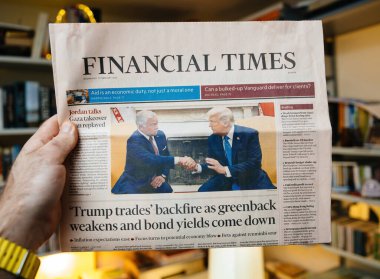 Paris, Fransa - 19 Şubat 2025: Sarı saat takan bir el, bir kütüphane odasında Ürdün Kralı II. Abdullah ile el sıkışan Donald Trump 'ın ön sayfadaki görüntüsünü yayınlıyor..