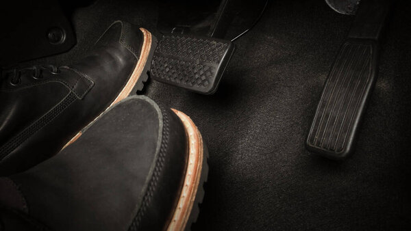 Car accelerate and brake foot pedal. Close up foot press or push foot break and accelerate pedal of a car to drive ahead. Driver driving the car by pressing or pushing accelerator pedals of the car.