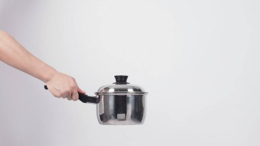 Pot cleaning Man hand on white background cleaning the non stick pot with handy dish washing sponge which yellow color on the soft side and green on hard side for hygiene after cook. Electric pot