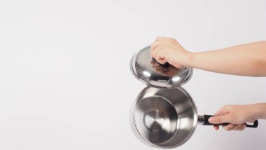 Pot cleaning Man hand on white background cleaning the non stick pot with handy dish washing sponge which yellow color on the soft side and green on hard side for hygiene after cook. Electric pot