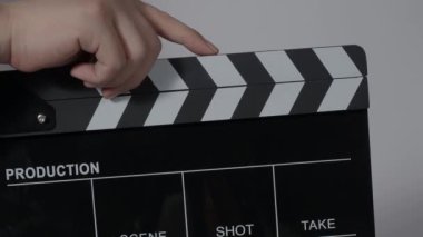 Film tahtası ya da el çırpma tahtası kayıt çerçevesiyle vuruyor. El ele tutuşup boş film tahtasını tutarak ve kameranın önünde alkışlayarak. Bir video prodüksiyonu çekerken açık ve kapalı film sayfası