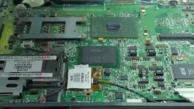 Bir bilgisayar anakartını kapatırken lazer taramasında hata oluştu. Modern Ai bilgisayarında entegre devreler, bağlayıcılar ve anahtar bileşenler taranıyor..