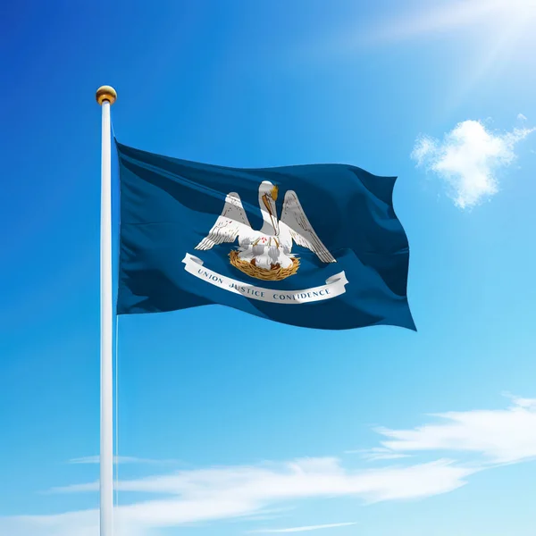 Waving flag of Louisiana is a state of United States on flagpole with sky background.