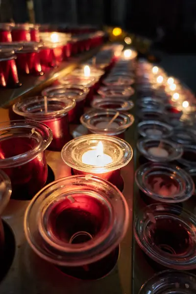 stock image Rows of lit and unlit votive candles in a Christian church, inside the Salamanca Cathedral, in Castilla y Leon, Spain