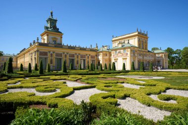 Historical palace at garden in Wilanow in european Warsaw city of Poland in Masovian voivodeship, clear blue sky in 2022 warm sunny spring day on May. clipart