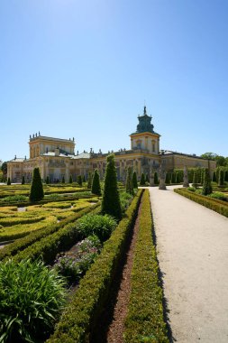 Route with palace at Wilanow in european Warsaw capital city of Poland in Masovian, clear blue sky in 2022 warm sunny spring day on May - vertical clipart