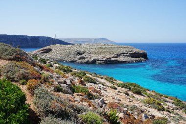 Exotic blue lagoon at european Comino island in Malta, clear blue sky in 2022 warm sunny spring day on May.