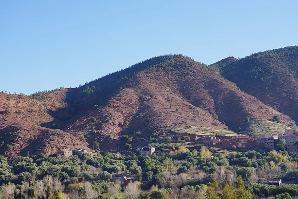 Fas 'ın Afrika kenti yakınlarındaki Ourika Vadisi' ndeki dağlar, 2023 yılının güneşli kış gününde açık mavi gökyüzü..