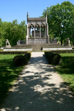 Stony mausoleum of Potocki at Wilanow in European Warsaw capital city of Poland, clear blue sky in 2022 warm sunny spring day on May - vertical clipart