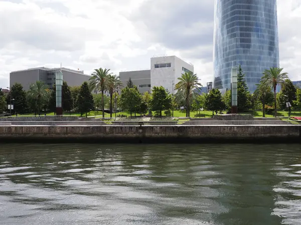 stock image Nervion river and modern tower in European BILBAO city at Biscay in Spain, cloudy sky in 2019 warm sunny summer day on September.