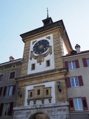 Old clock tower in European Murten town at canton of Fribourg in Switzerland, clear blue sky in 2018 warm sunny summer day on August - vertical clipart