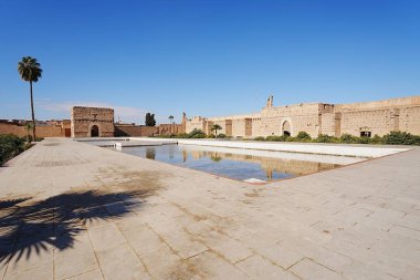 Pool in courtyard of El Badi palace in African MARRAKESH city in MOROCCO, clear blue sky in 2023 warm sunny winter day on January. clipart