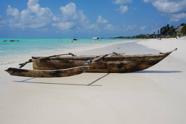 Tanzanya 'daki Afrika Zanzibar adasındaki Hint Okyanusu' ndaki Jambiani sahilinde balıkçı teknesi, 2024 'te güneşli bir yaz gününde açık mavi gökyüzü..