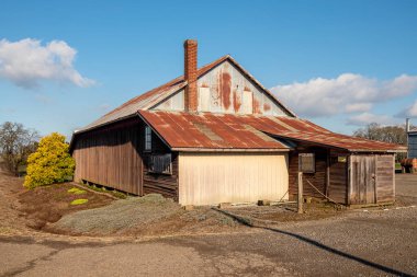 Rusted rooftops farming equipment in a country Willamette valley Oregon state.