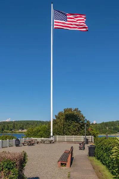 stock image Old Glory blowing in the wind in Port Gamble Washington state. 