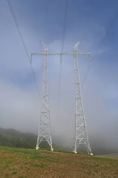 Tower for high voltage transmission line of the Czech transmission system in fog.