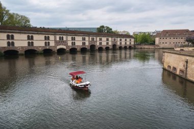 Tourists enjoy navigate in an electric boat on the river Ill in city center Strasbourg 