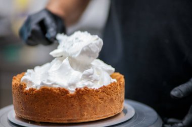 Yemek şefi profesyonel mutfakta limonlu turta hazırlıyor.