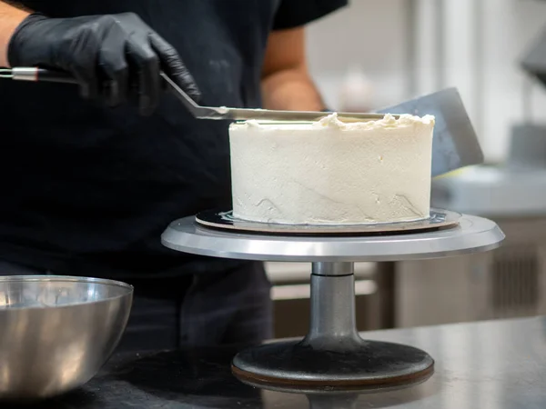 chef at work preparing a drip cake