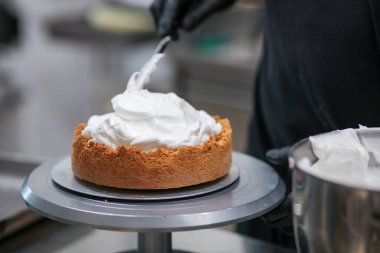 Yemek şefi profesyonel mutfakta limonlu turta hazırlıyor.