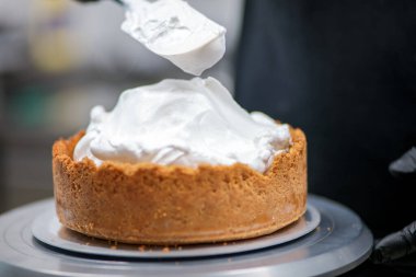 Yemek şefi profesyonel mutfakta limonlu turta hazırlıyor.