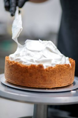 Yemek şefi profesyonel mutfakta limonlu turta hazırlıyor.