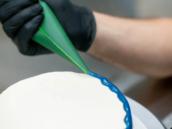 stock image pastry chef cake designer preparing blue white cheesecake in kitchen lab