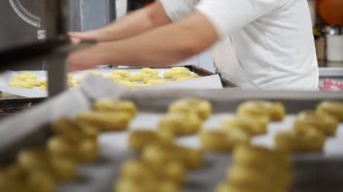 Pasta işçisi fırında kısa hamurlu tatlı kurabiyeler hazırlıyor.