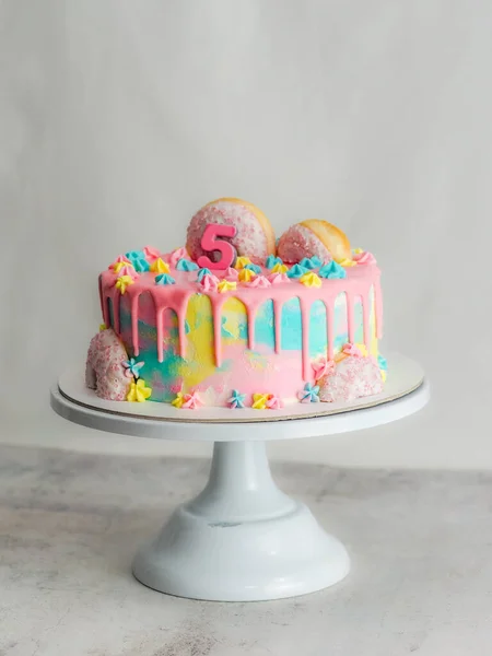 用甜甜圈和毛绒刷过的皇家星光洒落在白色的工作室镜头上的粉红糖霜蛋糕的特写 — 图库照片