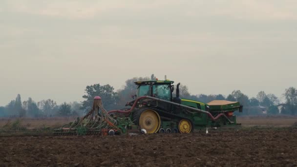 意大利克雷莫纳 2022年11月 绿色履带拖拉机抚平肥料和播种土壤 — 图库视频影像