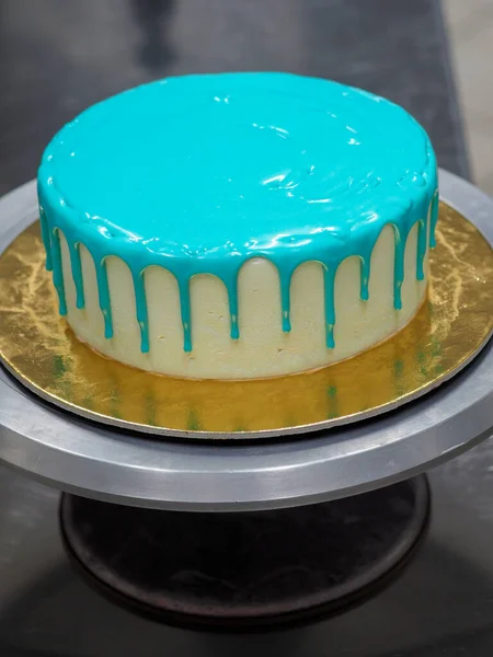 stock image bag piping filling topping on frosted icing drip turquoise cake for birthday celebration