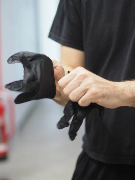 stock image chef put on black gloves in a professional kitchen before cooking vertical footage